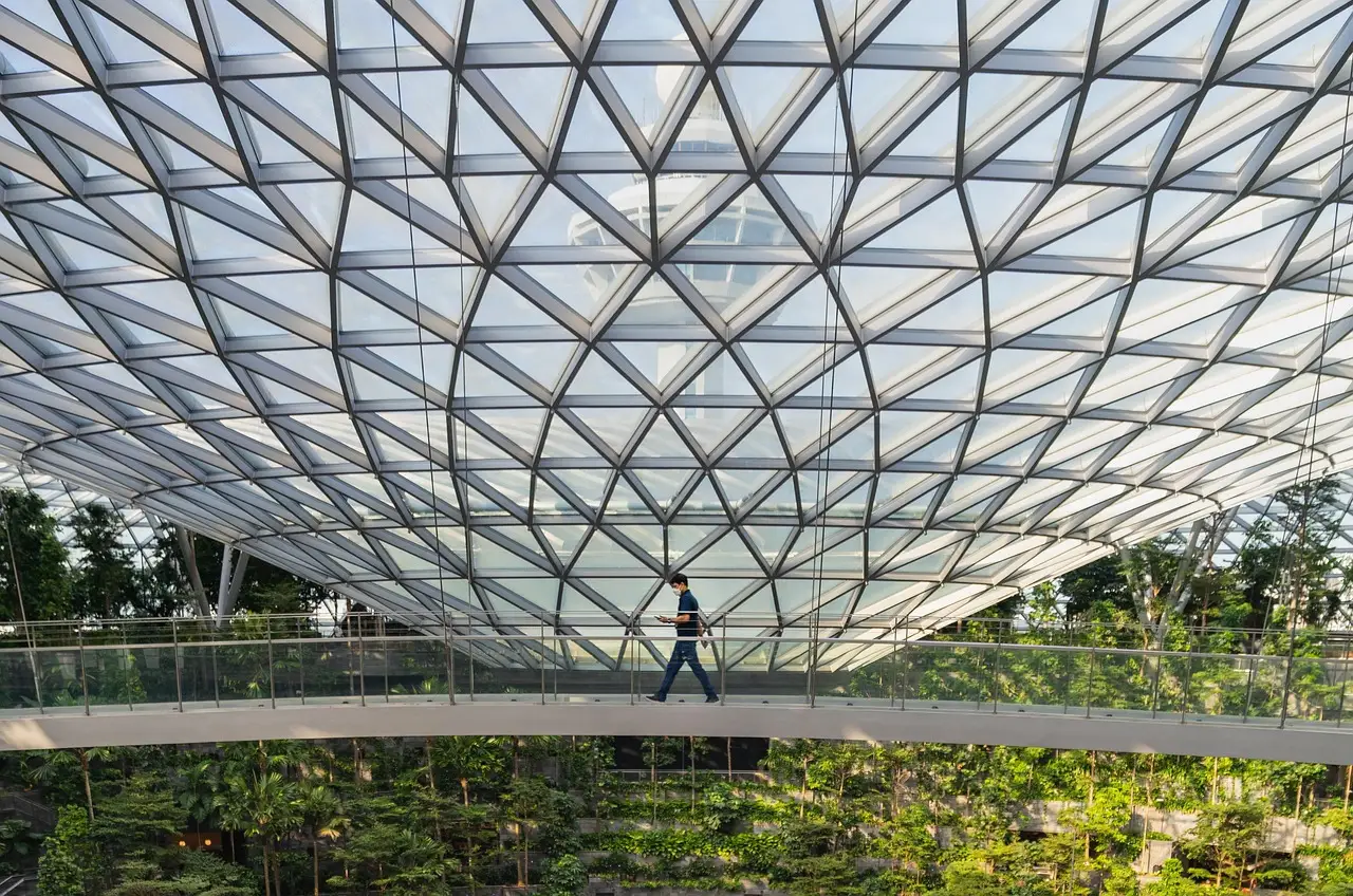 A glass canopy flooding the garden walkway with daylight